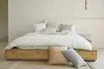 white bed pillow on brown wooden bed frame